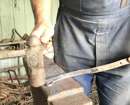 Blacksmithing with a hammer on an anvil